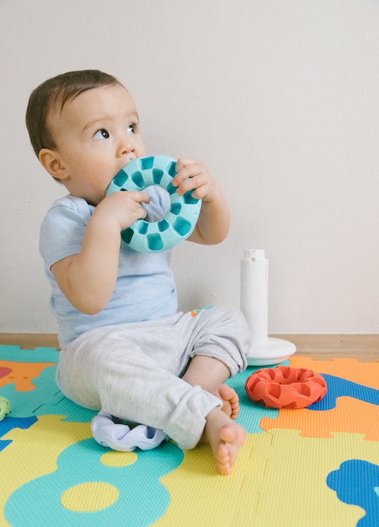A baby playing in a puzzle mat