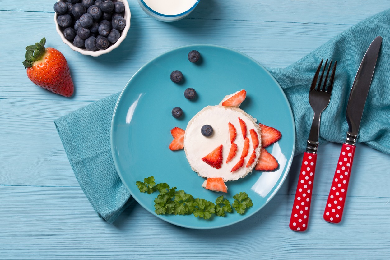 A kid’s plate with toast and berries on the side