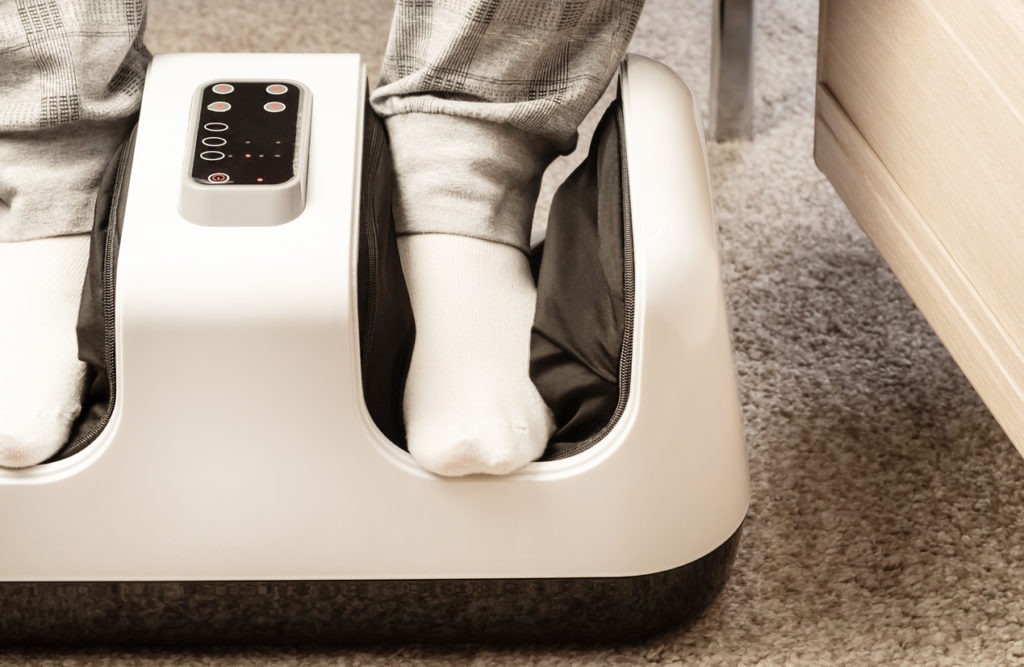 An electric foot massager in use