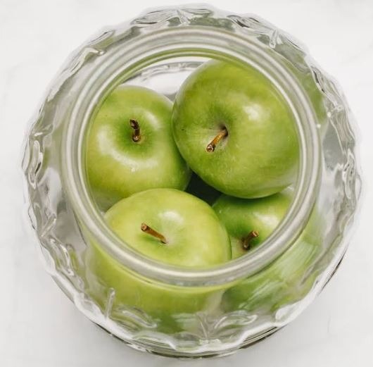 Apples in a glass bowl.