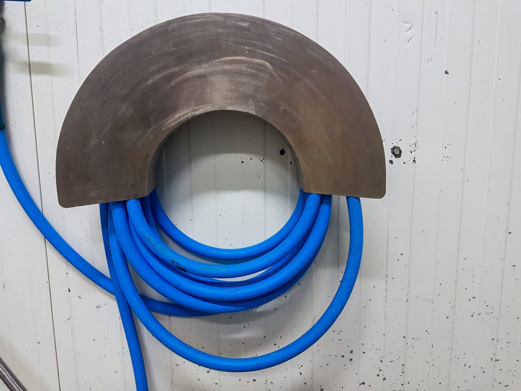 A garden hose unrolled from a reel