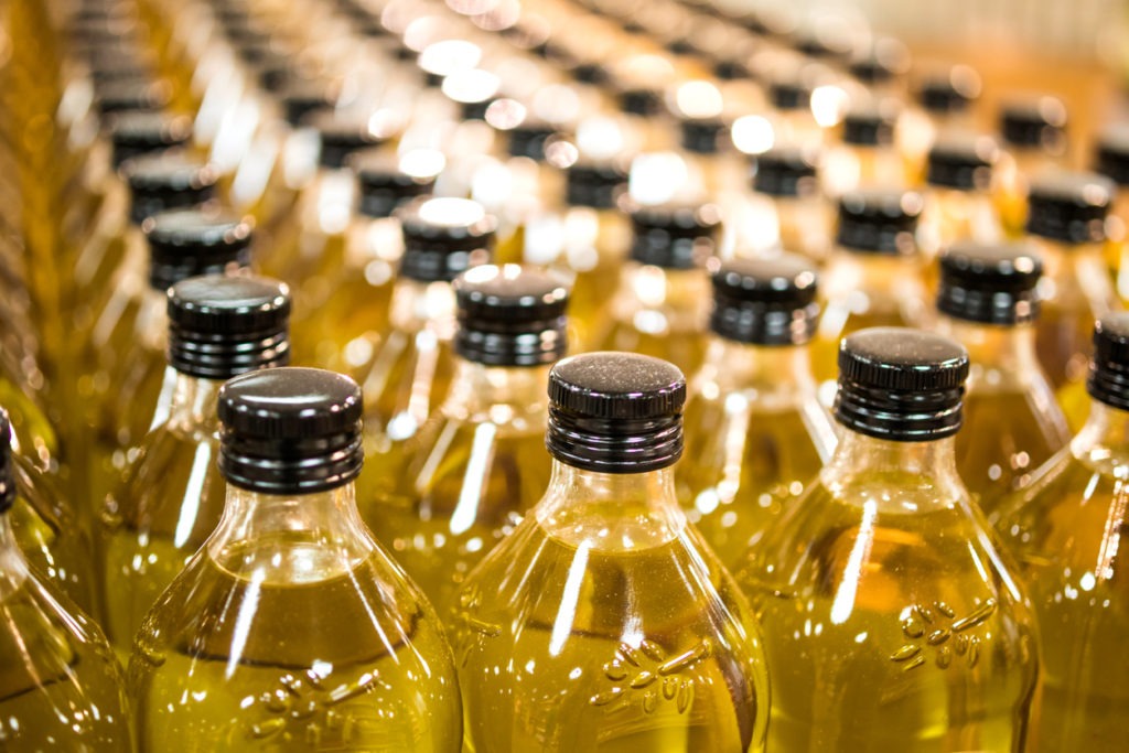 Bottles of flaxseed oil in production area of a factory. 