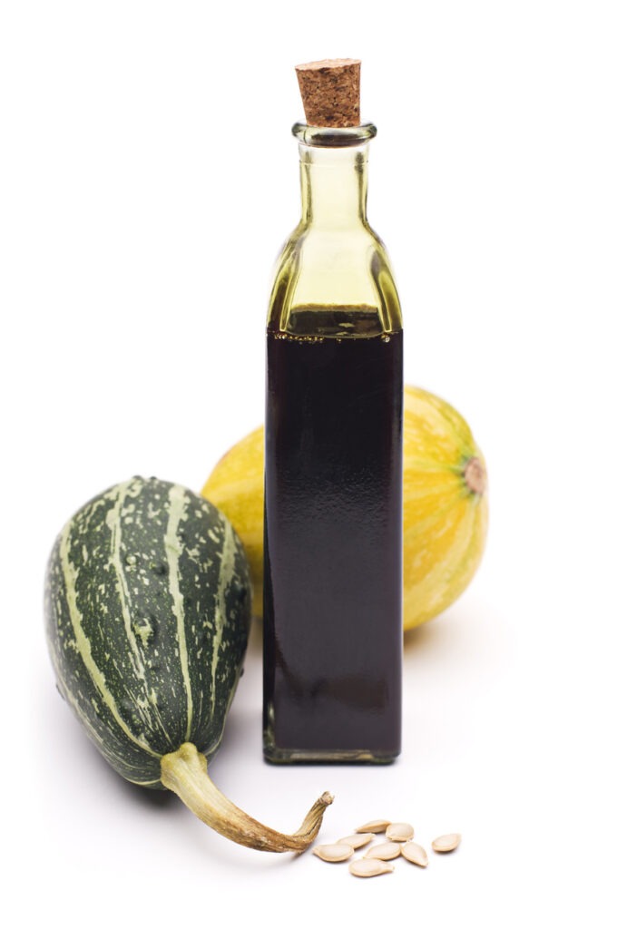 Close-up of fresh pumpkin oil on a white background