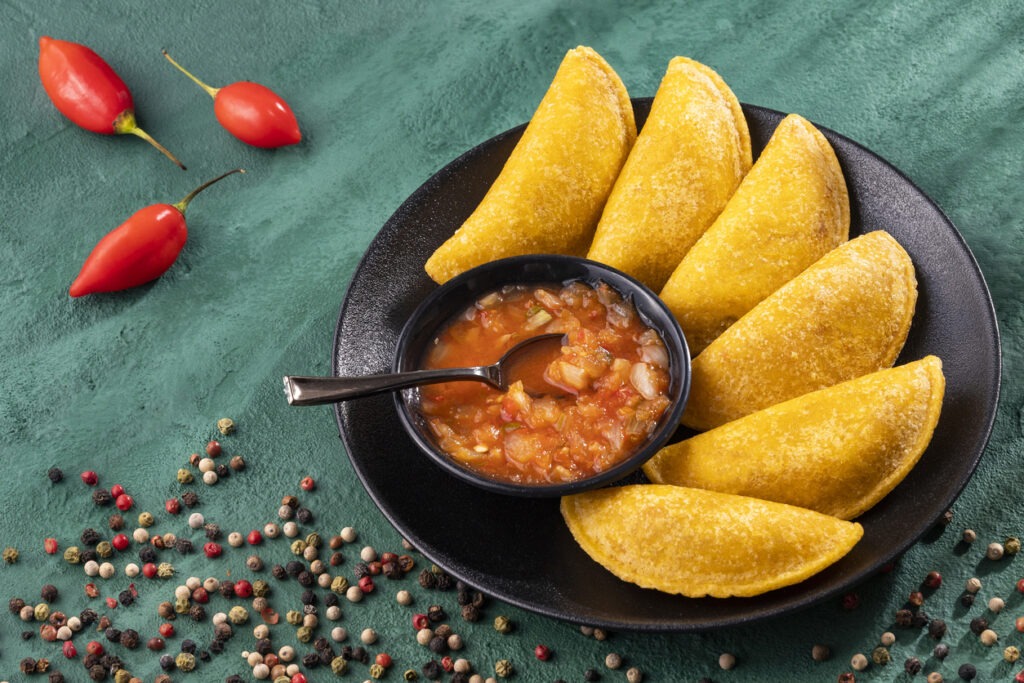Colombian food staples include fried empanadas with hot sauce