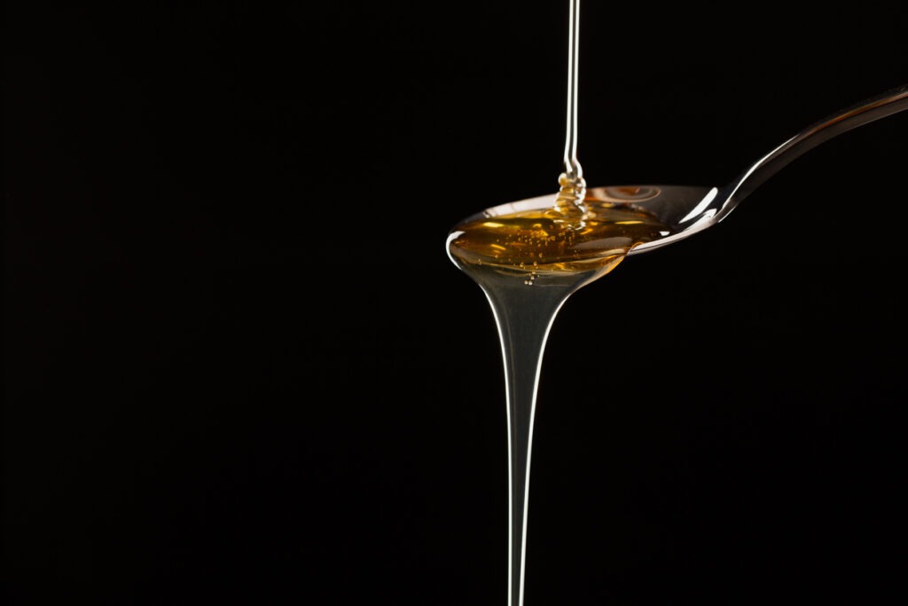 Hemp oil is poured into a spoon