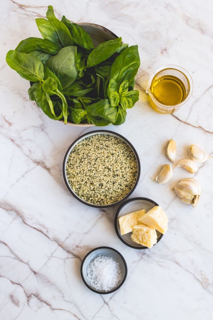 Ingredients for hemp pesto on a marble surface