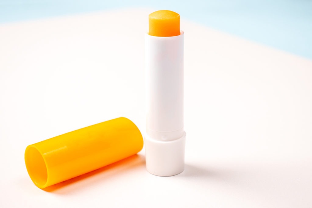 Lip balm in a hygienic container isolated on a white background. 