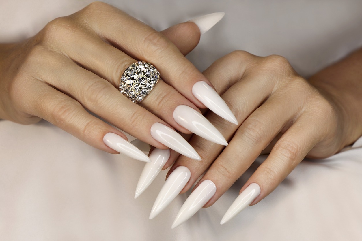 Long light manicure with ring.