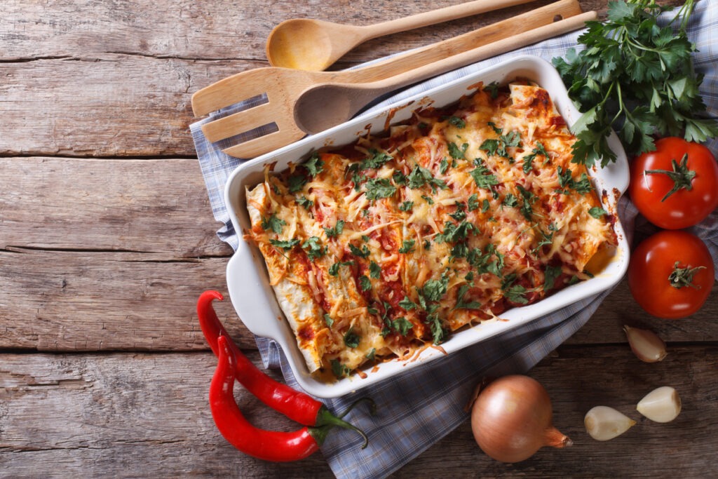 Mexican enchilada prepared using the items on the table and placed in a baking dish