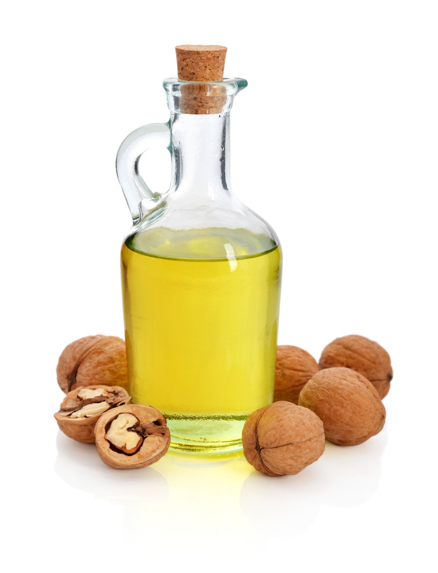 Nuts with walnut oil isolated on a white background