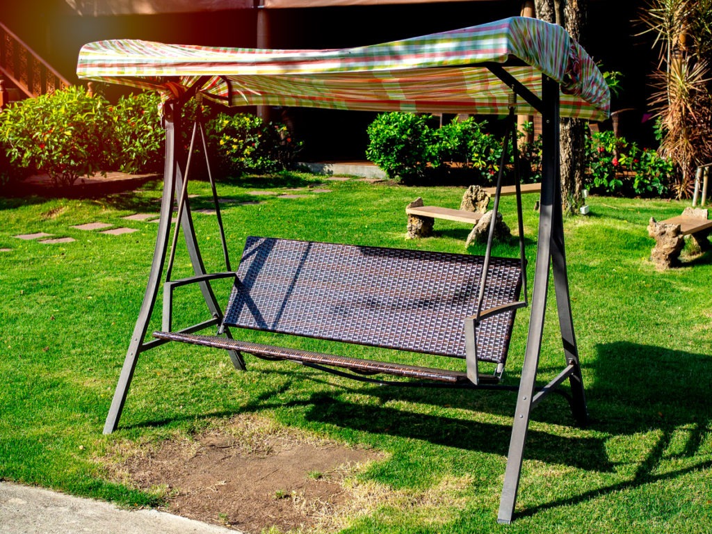 Rattan outdoor garden swing seat with canopy.
