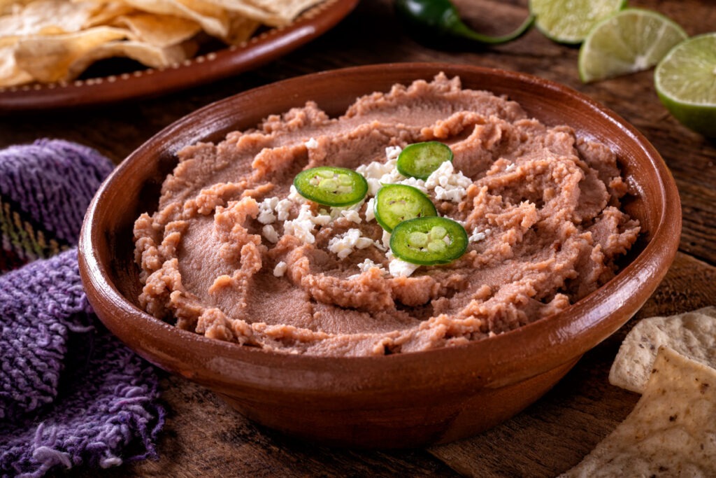 Refried beans prepared in the Mexican way, topped with queso fresco and jalapenos