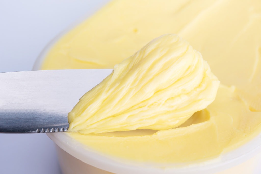 Spreading cheese butter or margarine with a knife. 