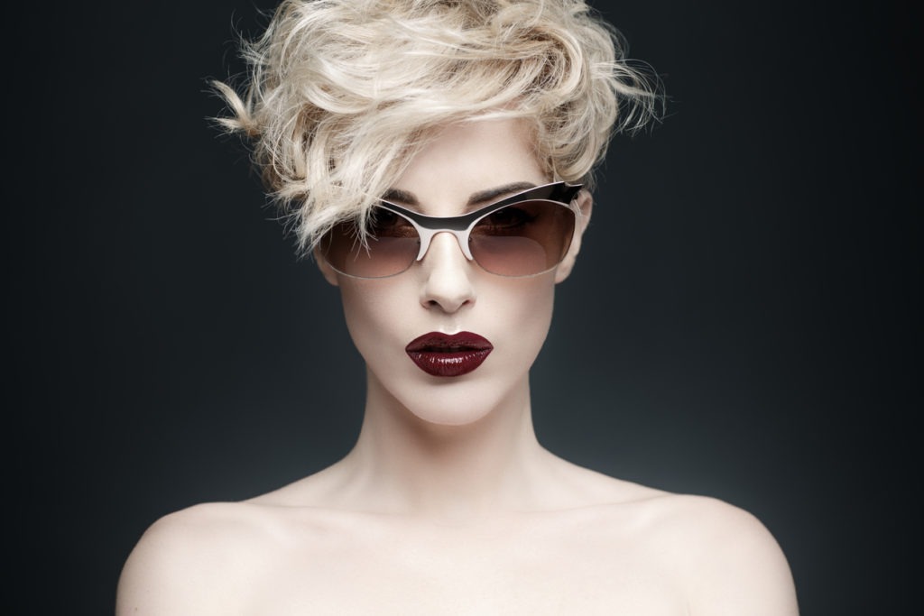 Studio shot of a woman with rounded sunglasses 