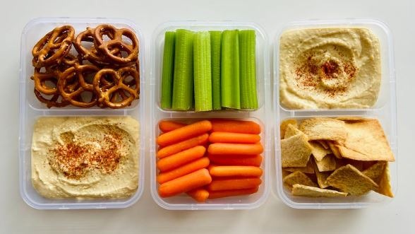 Vegan packed snacks in plastic containers.