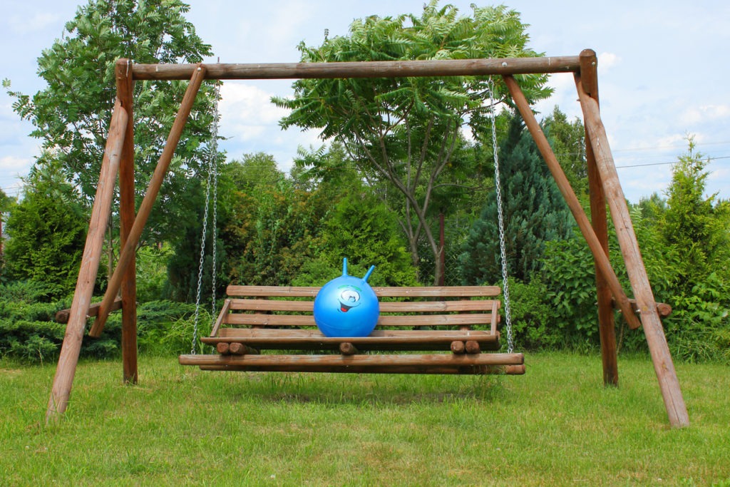 Wooden garden seat with blue bounce ball.