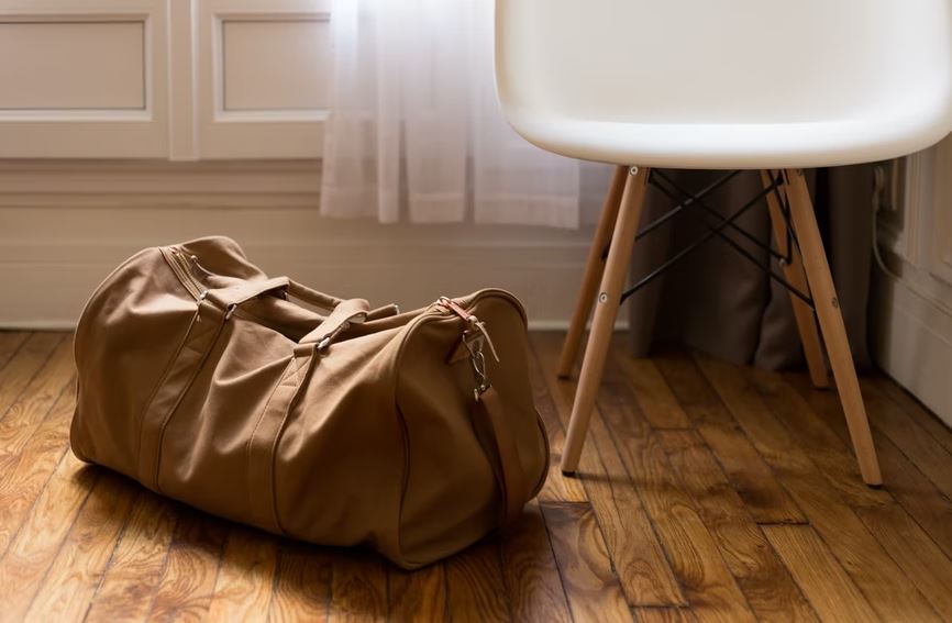 a brown canvas duffel bag on the floor