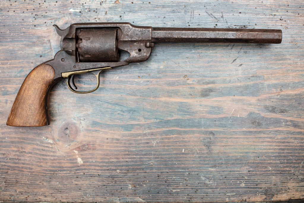 A historical pistol on vintage wooden table