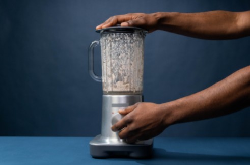 a-pair-of-hands-operating-a-cordless-blender