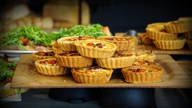 a-picture-of-miniature-quiches-stocked-in-a-pile