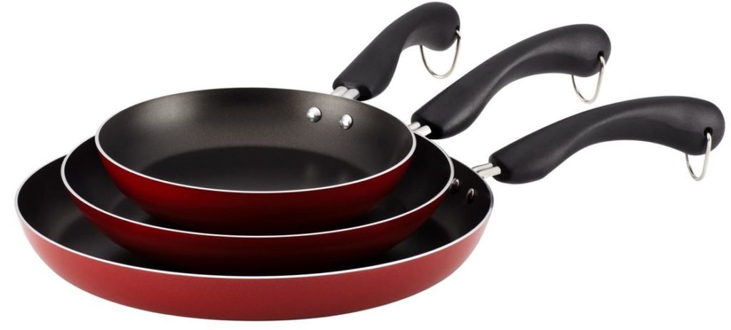 a set of stacked red non-stick pans against a white background