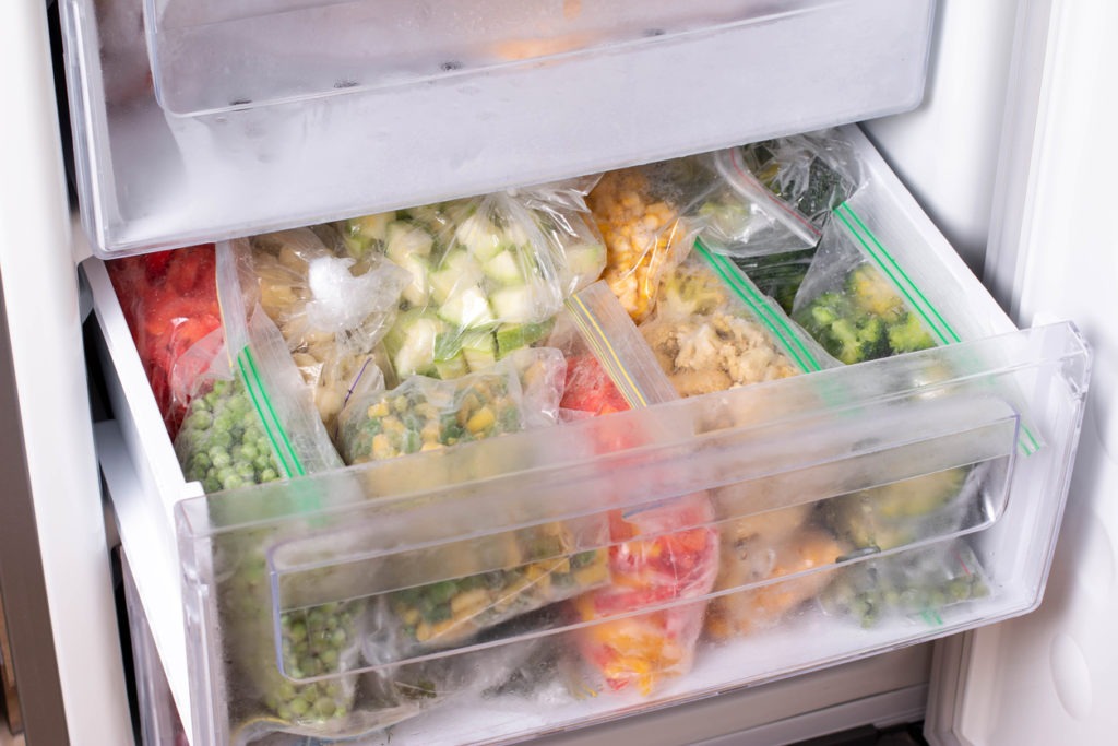 assortment of frozen vegetables in home fridge