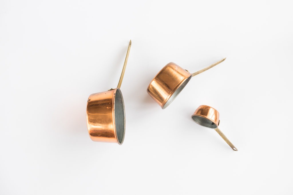 Copper Measuring Cups on a White Background
