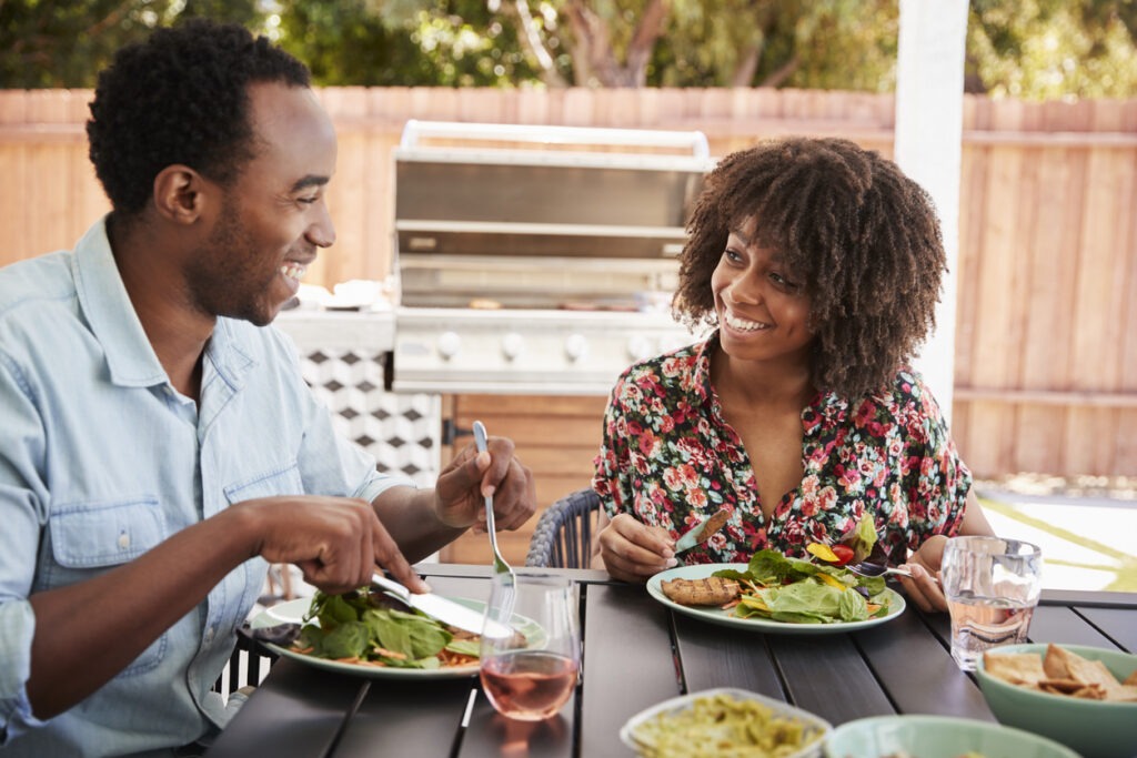 couple eating salad outdoors