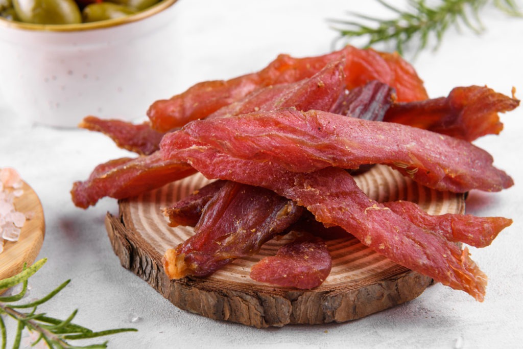 Jerky meat strips with spices, olives,