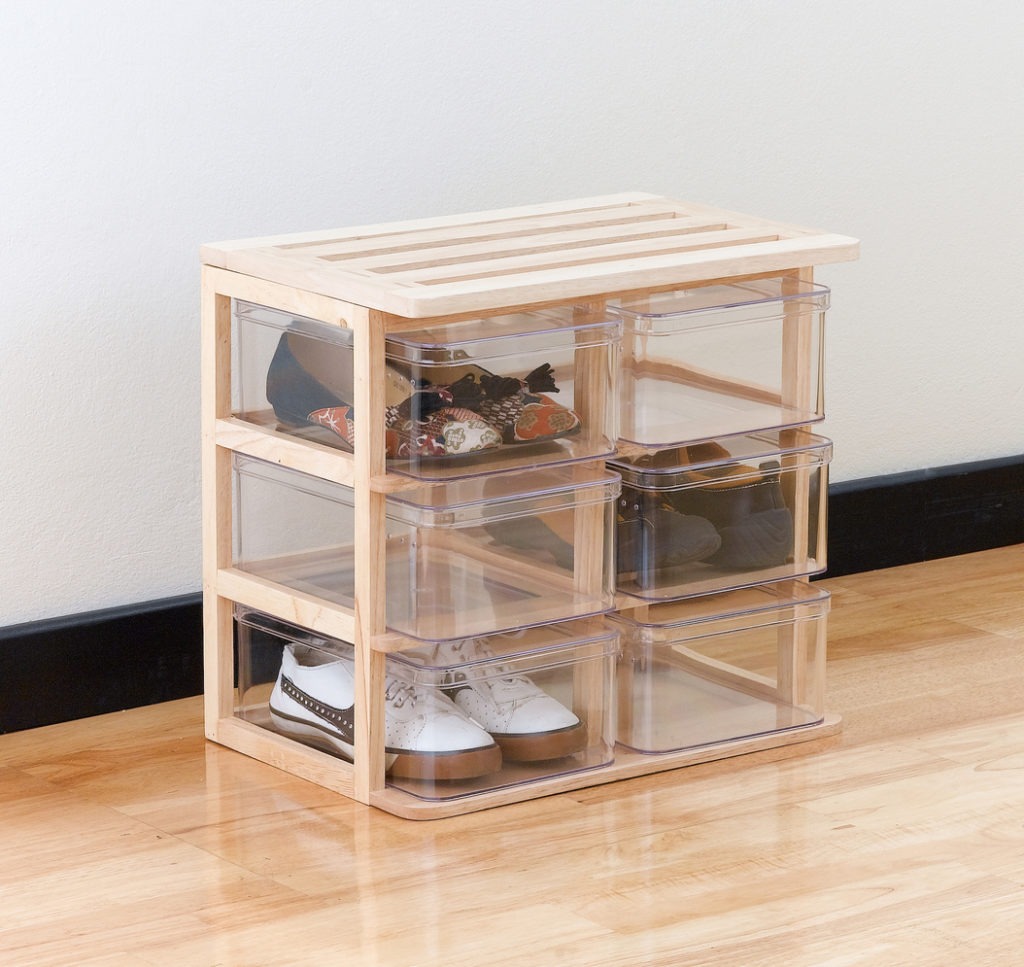 A modern design of shoe boxes on a wooden stand for storage of the shoes