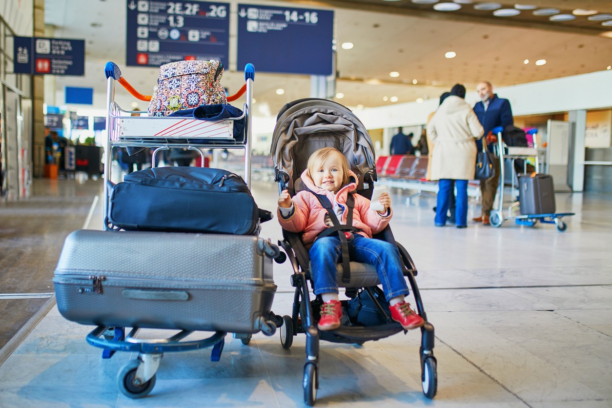 toddler in travel stroller