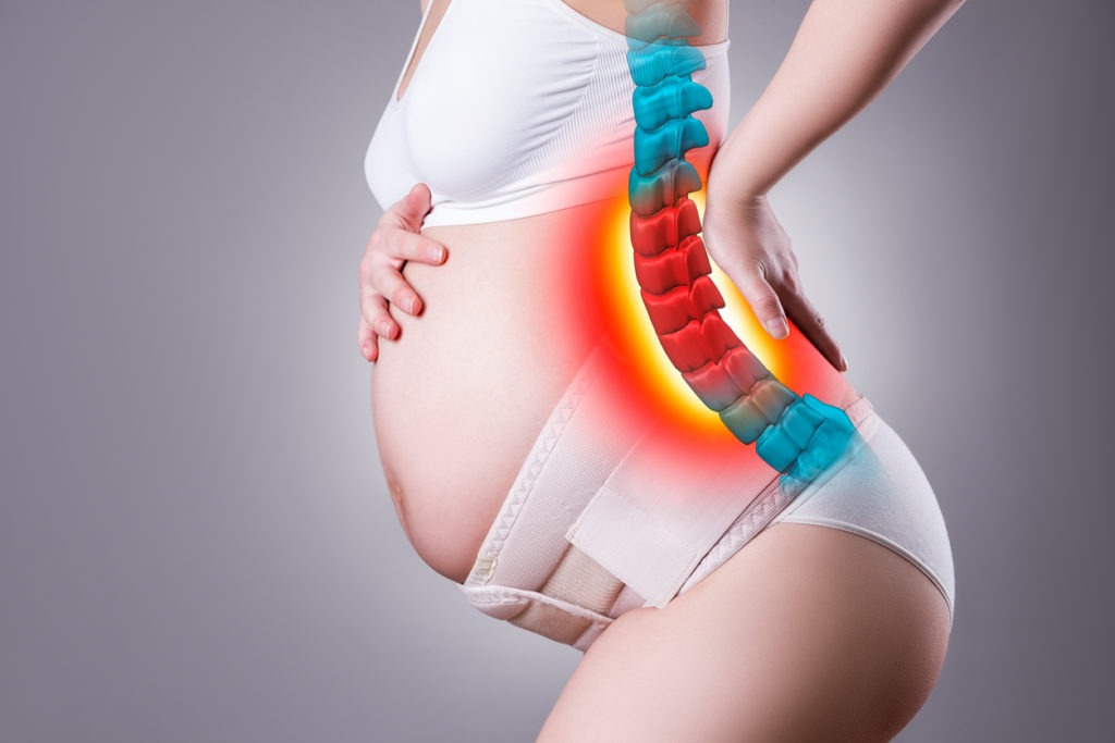 woman with back pain with maternity belt