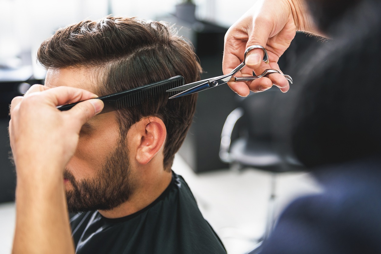 A man’s hair getting a haircut
