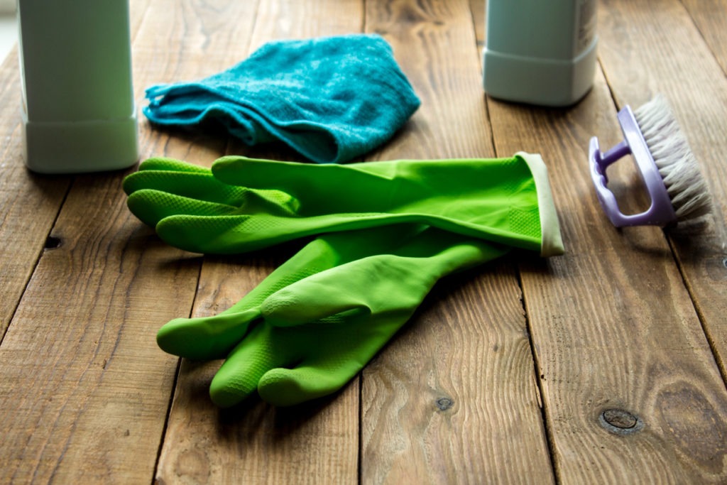 A pair of green rubber cleaning gloves