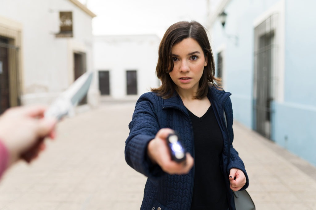 A woman using a stun gun for self-defense