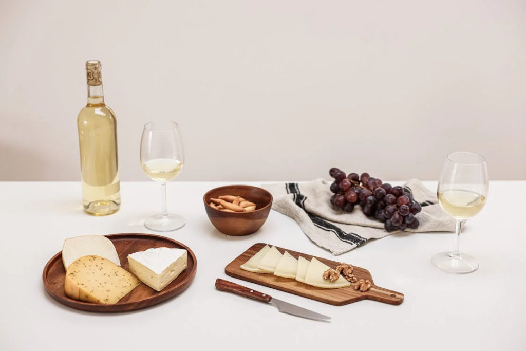 Assorted cheese with wine and grapes on a table