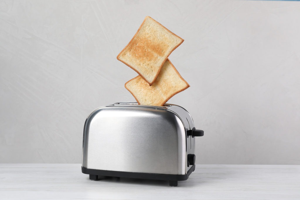 Bread slices popping up from a modern toaster
