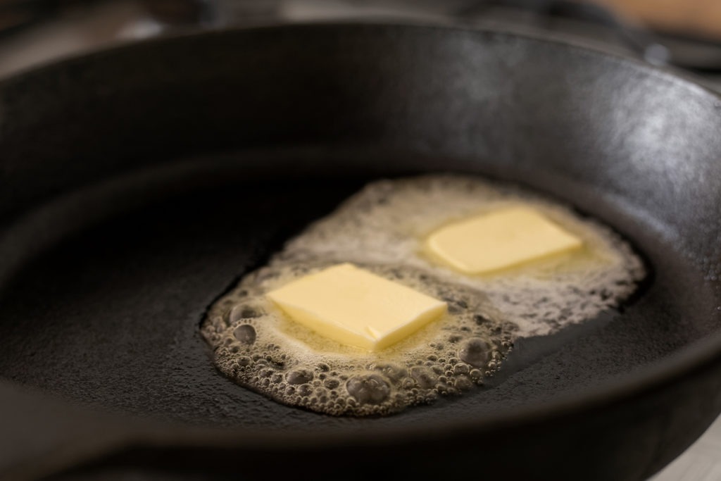 Butter melting on a cast iron pan