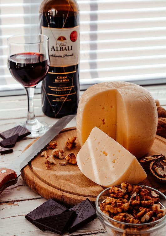 Cheese and wine on a wooden chopping boar