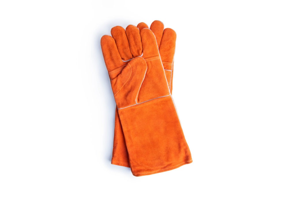 Coarse leather gloves on a white background