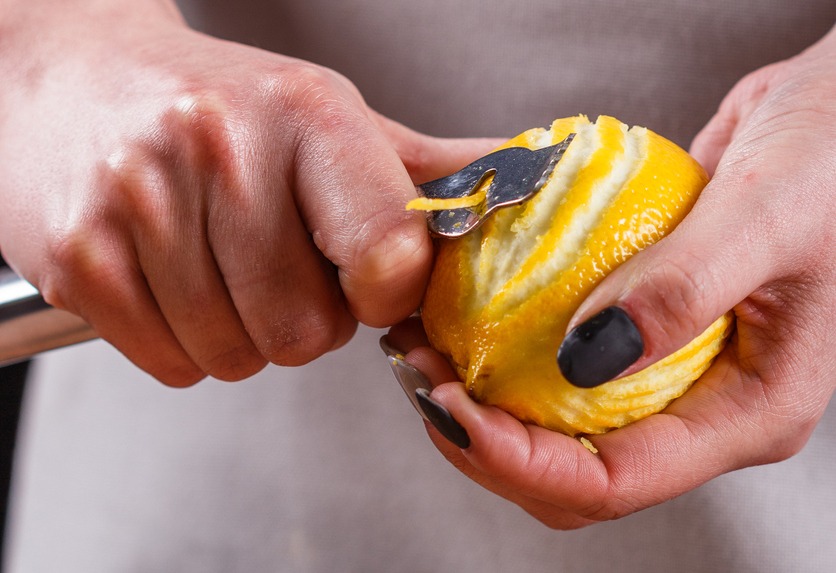 Hand peeling the lemon