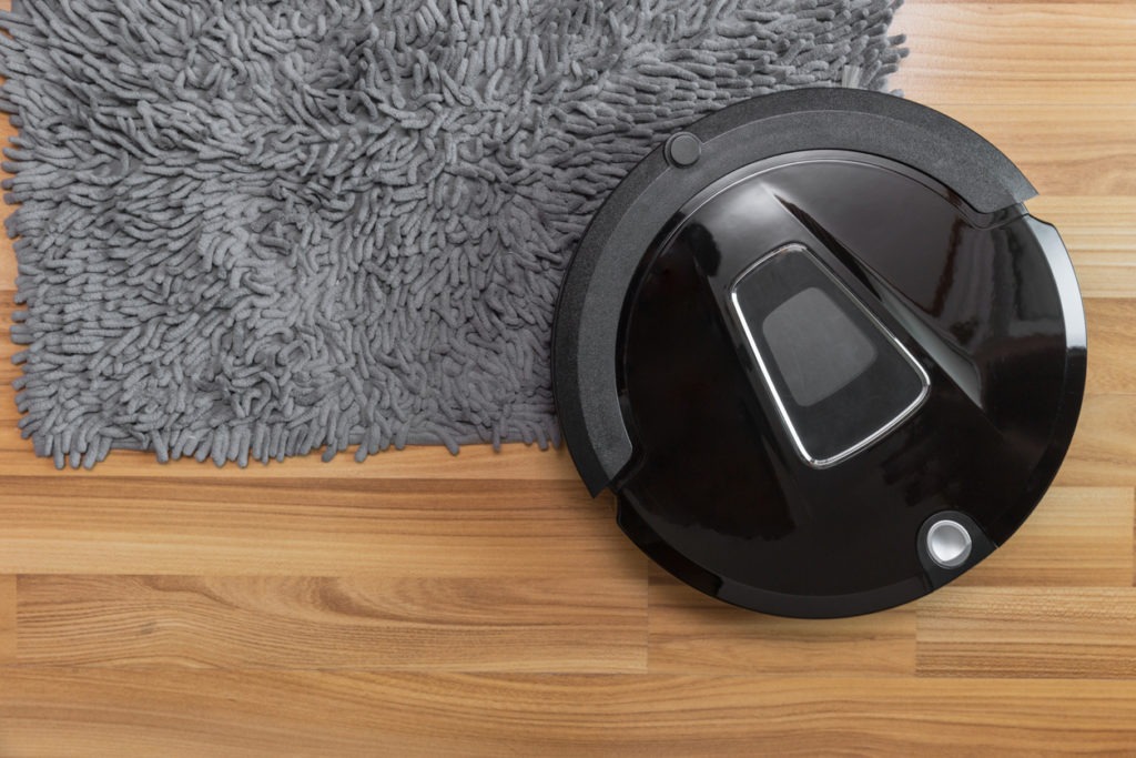 Hybrid robot mop on a laminate wood floor with carpet cleaning