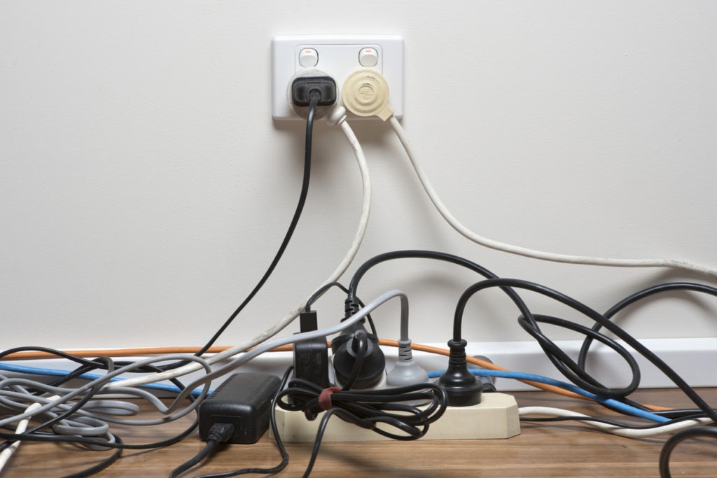 Messy cords connected to a single power socket.