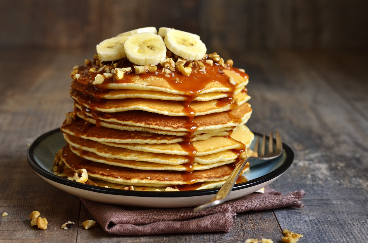 Pancakes with banana, walnut and caramel toppings