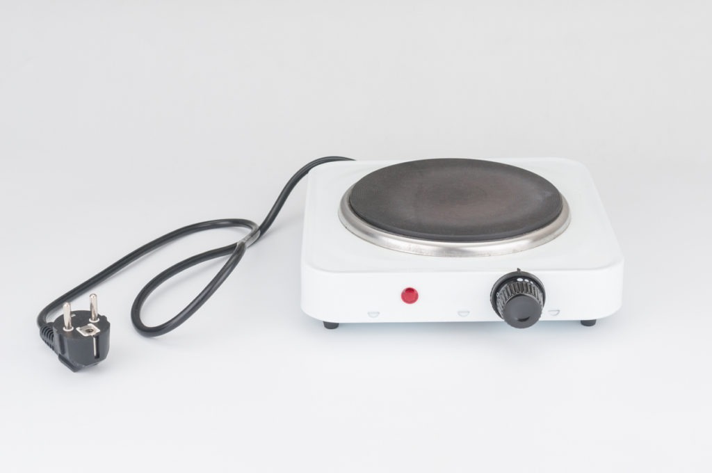 Portable electric stove on white background