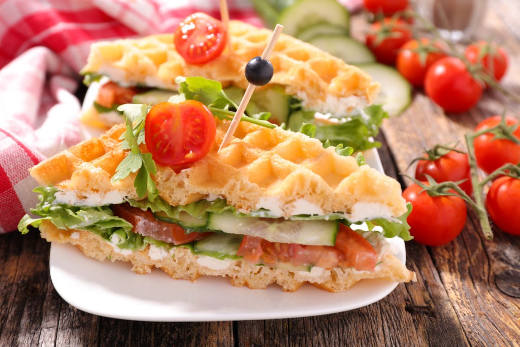 Waffle sandwich with fresh tomatoes, cucumber, and lettuce