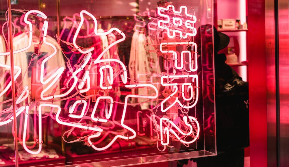 a pink neon signage in front of a store