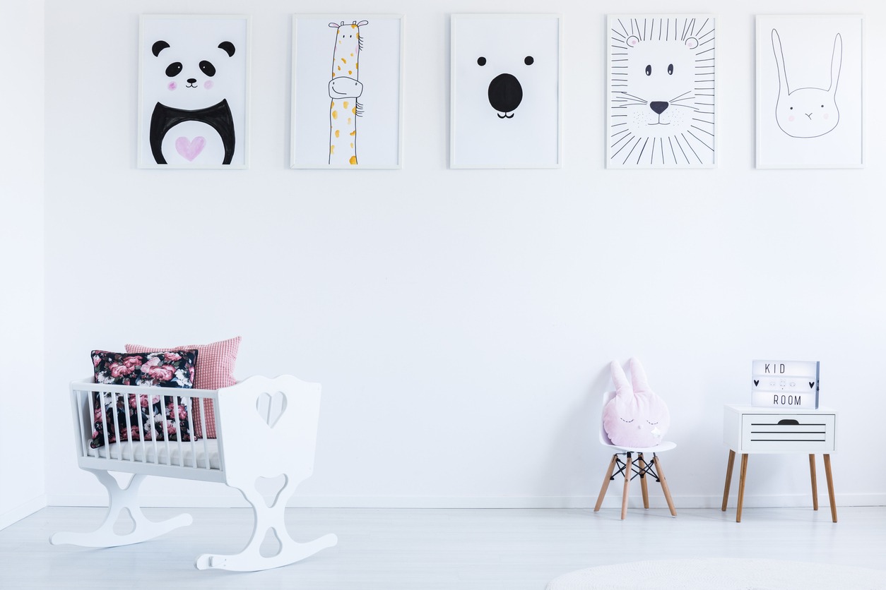 canvas paintings hang on a white wall