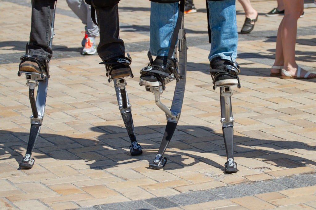 Legs of two men on a jumping stilts