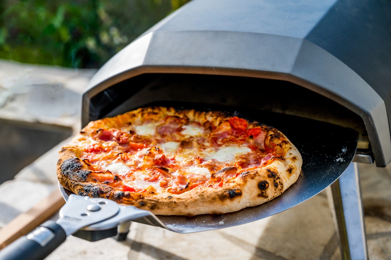 Making home made pizza in portable high temperature pizza oven